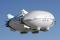 The hybrid airship demonstrator, called P-791, is 123 feet long, fifty-three feet wide, and thirty feet high, was built in 2005. First flight came on 31 January 2006. Company test pilot Eric Hansen made the first two flights and was followed by Bill Francis. The pilots sat side by side in an enclosed gondola with flight engineer Tim Blunck. A total of six flights, each about thirty minutes long, were carried out in the P-791 test program. The tests were mostly ground handling demonstrations. When out of ground effect, the airship crew remained in the traffic pattern at Palmdale, staying below 2,000 feet.