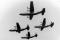The Four Horsemen were the world's only four engine per aircraft demonstration team. Flying four C-130As in close formation, the team would perform a number of manuevers over a twenty-three minute airshow. The team would takeoff and fly much of the demonstration in the diamond formation. The two wingmen flew with barely ten feet of horizontal separation between their wingtips and the horizontal tail of the lead and at the same altitude. The slot pilot flew seven to ten feet behind and slightly above the lead. This show the diamond during a low altitude pass.