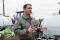 Maj. Phil Townsend, the chief of aerial spray with the 757th Airlift Squadron at Youngstown ARS, Ohio, standing in front of the herbicide loading equipment during deployed operations at Hill AFB, Utah.