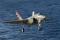 US Navy test pilot Lt. Cmdr. Theodore Dyckman guides F-35C CF-5 in for a landing aboard the USS Nimitz (CVN-68) on 5 November 2014, which was the third day of operations aboard the aircraft carrier.