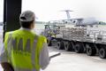 National Aeronautic Association observer Kris Maynard observes as members of Dover AFB, Delaware’s Aerial Port Squadron bring as pallets of stacked pallets are brought up to the scales to be weighed.