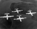 The Four Horsemen were the world's only four engine per aircraft demonstration team. Flying four C-130As in close formation, the team would perform a number of manuevers over a twenty-three minute airshow. The team would takeoff and fly much of the demonstration in the diamond formation. The two wingmen flew with barely ten feet of horizontal separation between their wingtips and the horizontal tail of the lead and at the same altitude. The slot pilot flew seven to ten feet behind and slightly above the lead.