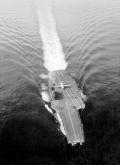 A broad dotted white line painted down the middle of the axial deck greeted the KC-130 crew on their first approach to the USS Forrestal. The ship's skipper put the carrier into the wind and added ten knots, which gave the flight crew a forty- to fifty-knot headwind over the bow.