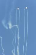 Two T-50s perform a synchronized line-abreast loop. The maneuver is followed by a split and a a double max turn (a max-g turn in opposite directions).