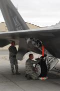 An armament system specialists with the 90th Aircraft Maintenance Unit performs checks on an F-22 Raptor prior to missile load on the flight line.