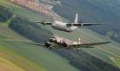 A C-47 Skytrain is flown alongside a C-130J Super Hercules from the 37th Airlift Squadron over Germany on 30 May 2014. The C-47 came to Ramstein AB, Germany, for a week to participate in base activities with its legacy unit, the 37th AS, before returning to Normandy to recreate its role and drop paratroopers over the original drop zone in Sainte-Mere Eglise, France.