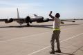 A ground crew member at Beale AFB directs the U-2 after a pilot training flight.