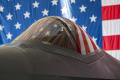 An F-35A with a US flag as a backdrop at Edwards AFB, California.