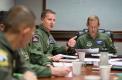 Lt. Col. Matt Jones, the 22nd AS commander, who served as the mission commander on the world record flight, makes a point during the crew briefing, as Maj. Jon Flowers, the aircraft commander on the flight, listens.
