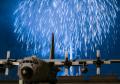 Fireworks explode behind a C-130 Hercules during Celebrate America ceremonies at Yokota AB, Japan, on 2 July 2015. Celebrate America is an annual event that provides military members and their families the opportunity to enjoy games, food, and bands before culminating in a fireworks display over the Yokota airfield to celebrate US Independence Day.