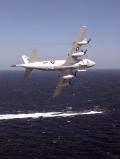A P-3C assigned to Patrol Squadron 30 (VP-30), the US Navy Orion training squadron, over a US nuclear submarine near Jacksonville, Florida, circa 2001.