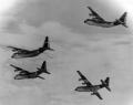 The Four Horsemen were the world's only four engine per aircraft demonstration team. Flying four C-130As in close formation, the team would perform a number of manuevers over a twenty-three minute airshow. For their finale, the team would come back toward the crowd in the diamond formation and performed the bomb burst – what they called the Horseman Burst – maneuver. The lead pilot pulled up and making a forty-five degree left turn while the right wing pulled up and made a ninety-degree right turn. Left wing pulled up and turned ninety degrees to the left, while the slot pilot climbed and made a forty-five degree right turn. This image shows the beginning of the Horsemen burst maneuver.