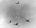 The Four Horsemen were the world's only four engine per aircraft demonstration team. Flying four C-130As in close formation, the team would perform a number of manuevers over a twenty-three minute airshow. For their finale, the team would come back toward the crowd in the diamond formation and performed the bomb burst – what they called the Horseman Burst – maneuver. The lead pilot pulled up and making a forty-five degree left turn while the right wing pulled up and made a ninety-degree right turn. Left wing pulled up and turned ninety degrees to the left, while the slot pilot climbed and made a forty-five degree right turn. This image shows the Horsemen burst maneuver after the pilots separated.