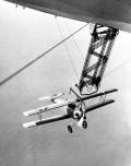 The Navy ordered six Fleet 2 tandem seat trainers from Consolidated in 1929 to be used as ‘sky hook’ trainers. On 3 May 1932, hook-on training operations began with the Navy’s newest rigid airship, the USS Akron (ZRS-4). Flying N2Y-1 trainers equipped with top wing-mounted hook apparatus, Aviators would catch the airship’s trapeze gear in flight and were then brought into the airship’s hangar bay.