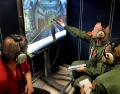 Loadmasters go through their own academic and hands-on training with an instructor at Little Rock AFB, Arkansas. Initial training consists of a combination of actual hardware and computer-generated images on large displays, as shown here. These video lessons include things like releasing simulated loads. Once the students have mastered the various parts of the cargo compartment, training moves to the FuT, or Fuselage Trainer, a full-sized simulator with working systems that resides on the flightline.