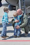Maj. Tony Bradley greets two of his sons on the flight line of the 132nd Fighter Wing (132FW), Des Moines, Iowa, after returning home from deployment in Kandahar, Afghanistan.