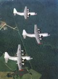 Three of the aircraft involved in the C-130J test program are flown in formation over Alabama in this shot from about 1998. The top two aircraft are the long fuselage version, while the aircraft in the foreground is a standard-length C-130J. The stretch models were delivered to the Royal Air Force; the standard length C-130J was delivered to the US Air Force.