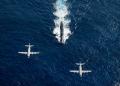 A Japanese Maritime Self Defense Force and a US P-3 Orion patrol aircraft are flown over the Los Angeles-class attack submarine USS Houston (SSN-713) during a recent exercise.